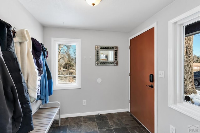 mudroom with stone finish flooring and baseboards