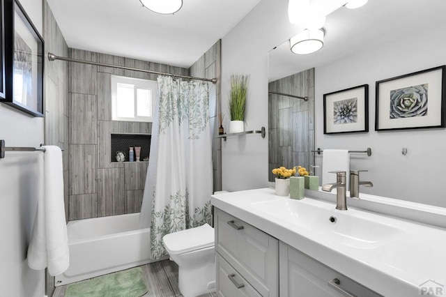 bathroom featuring shower / tub combo, vanity, and toilet