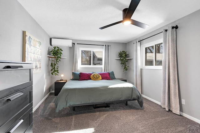 carpeted bedroom with ceiling fan, a textured ceiling, baseboards, and a wall mounted AC