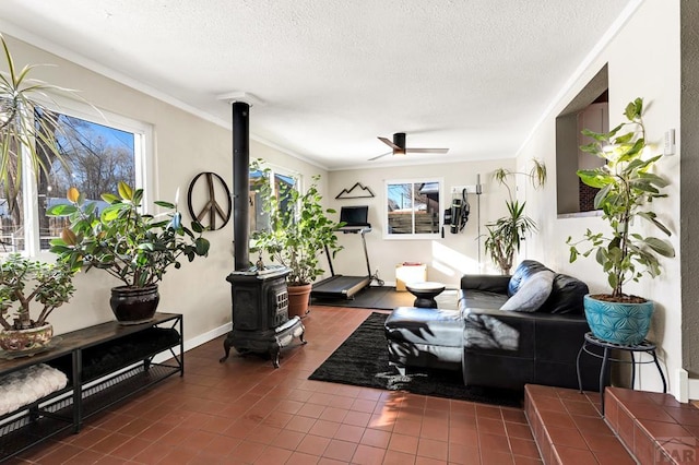 living room with a textured ceiling, a wood stove, and crown molding