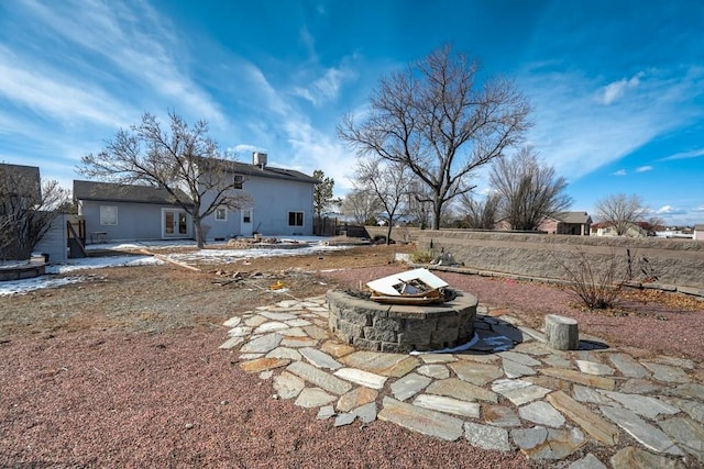 view of yard featuring an outdoor fire pit, fence, and a patio