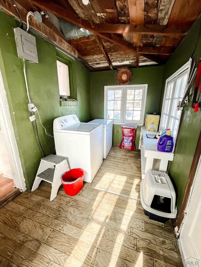 washroom with washer and dryer, laundry area, and light wood finished floors