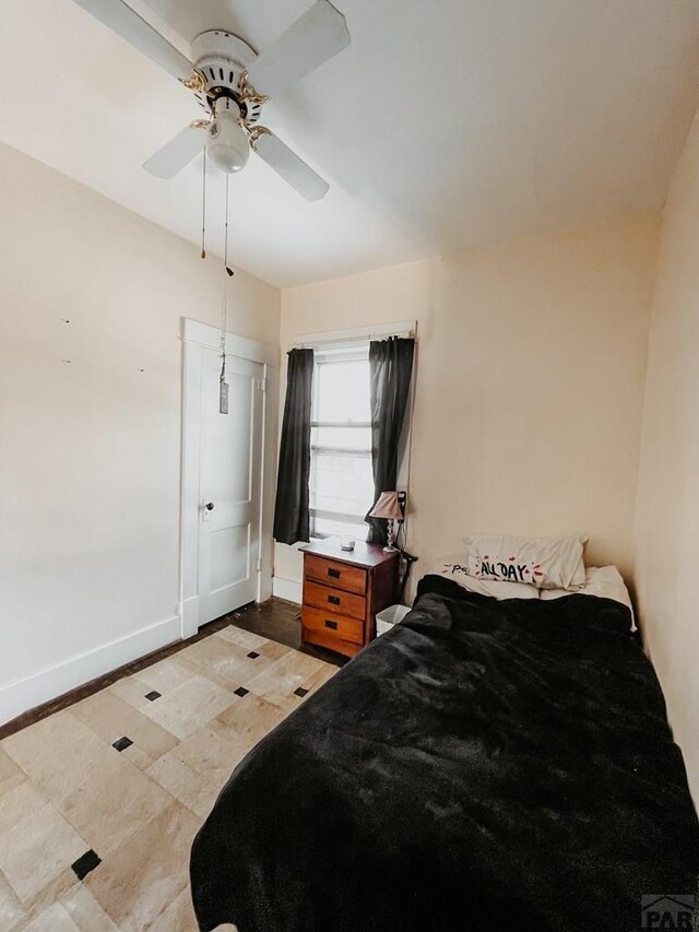 bedroom featuring ceiling fan and baseboards