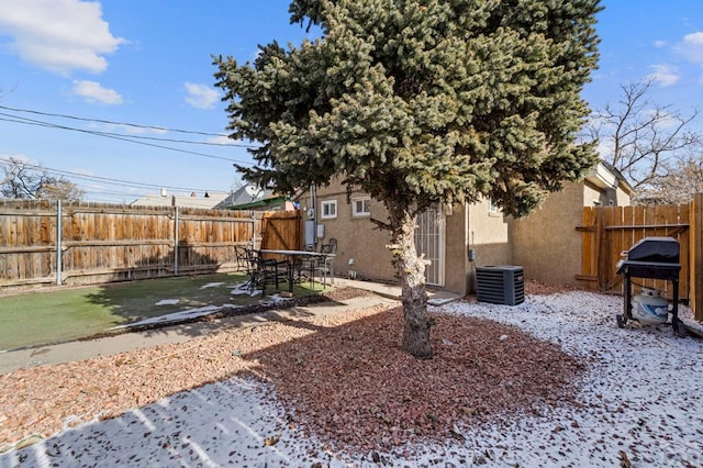 view of yard featuring a fenced backyard and central AC unit