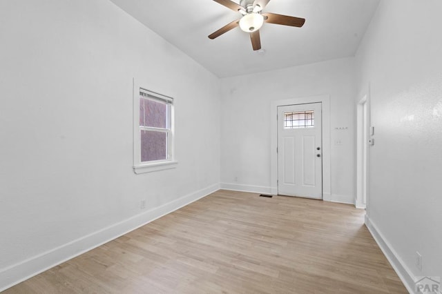 foyer featuring light wood-type flooring, a ceiling fan, and baseboards