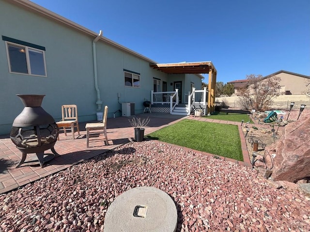 back of property featuring central AC, a patio area, and stucco siding