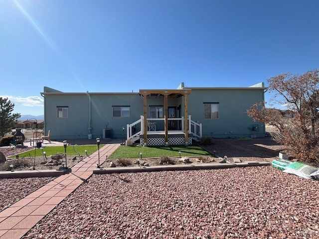 back of property featuring a lawn and central air condition unit