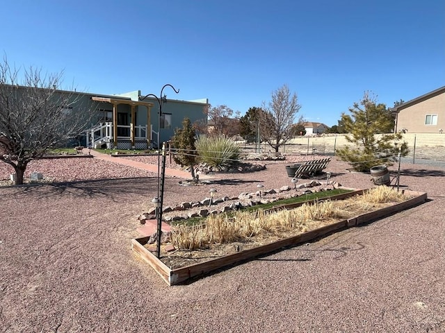 view of yard with a garden and fence