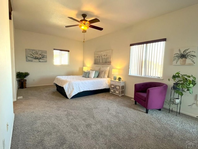 carpeted bedroom featuring ceiling fan and baseboards