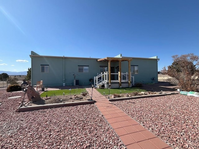 rear view of property featuring central AC and a patio area