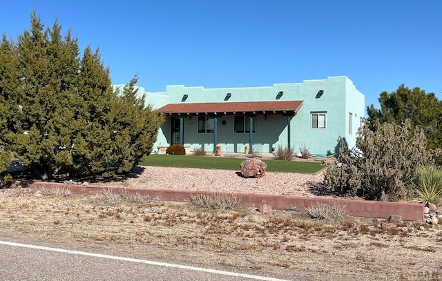 view of front of property with a front yard and stucco siding