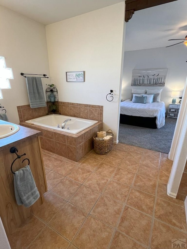 ensuite bathroom featuring a ceiling fan, a garden tub, ensuite bathroom, and tile patterned floors