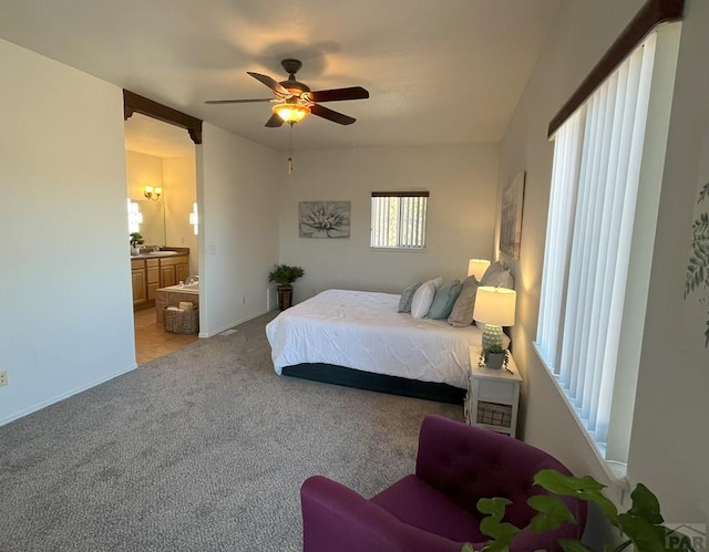 bedroom featuring ensuite bath, a ceiling fan, and light colored carpet