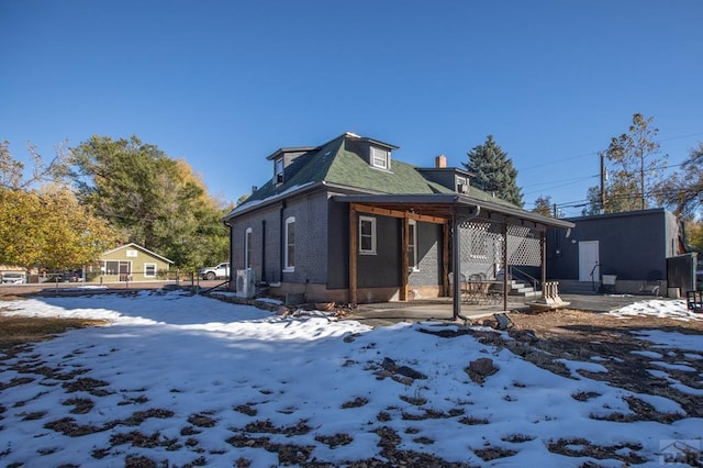 exterior space with entry steps and brick siding