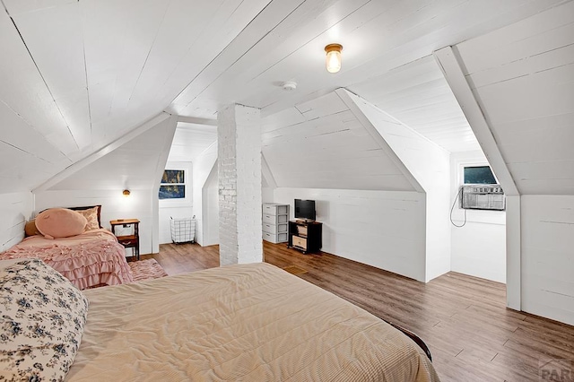 bedroom with lofted ceiling, wooden ceiling, wood finished floors, and an AC wall unit