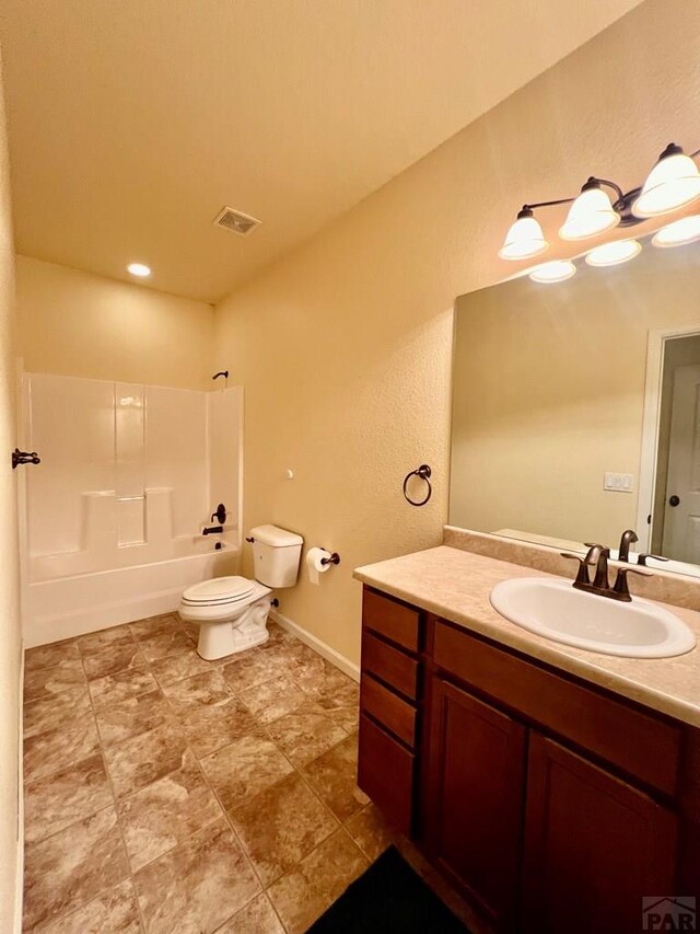 full bath with baseboards, vanity, toilet, and bathing tub / shower combination