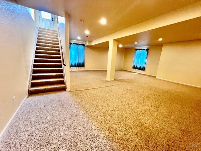 basement featuring stairway, recessed lighting, carpet flooring, and baseboards