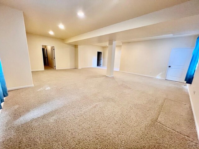 basement with light carpet, baseboards, and recessed lighting