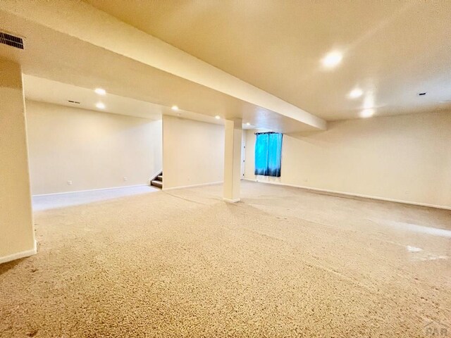 finished below grade area with carpet floors, recessed lighting, visible vents, baseboards, and stairs