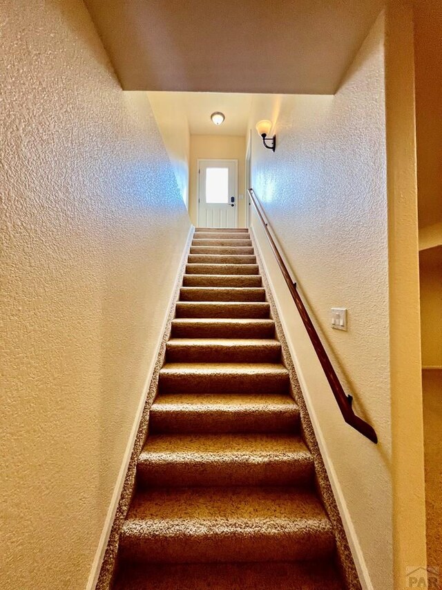 stairs with a textured wall