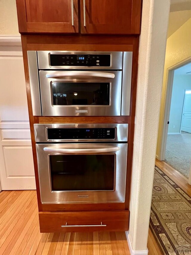 room details with light wood-style floors and brown cabinets