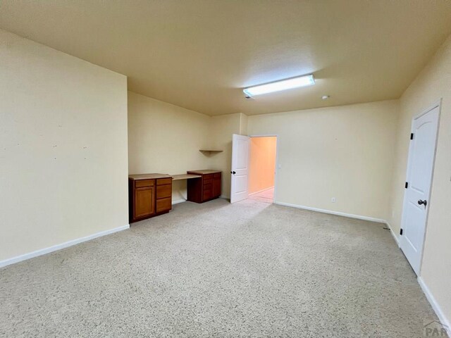 unfurnished room with baseboards