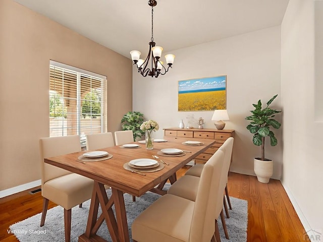 5522 Ventana Ct, Pueblo, CO 81005 - dining room with a chandelier and light wood-style flooring