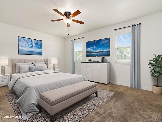 5522 Ventana Ct, Pueblo, CO 81005 - bedroom with light colored carpet, multiple windows, and ceiling fan
