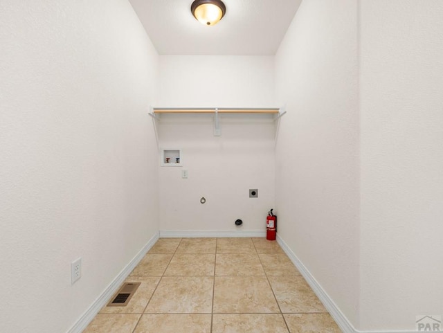 5522 Ventana Ct, Pueblo, CO 81005 - laundry area featuring hookup for a gas dryer, hookup for a washing machine, light tile patterned floors, and hookup for an electric dryer