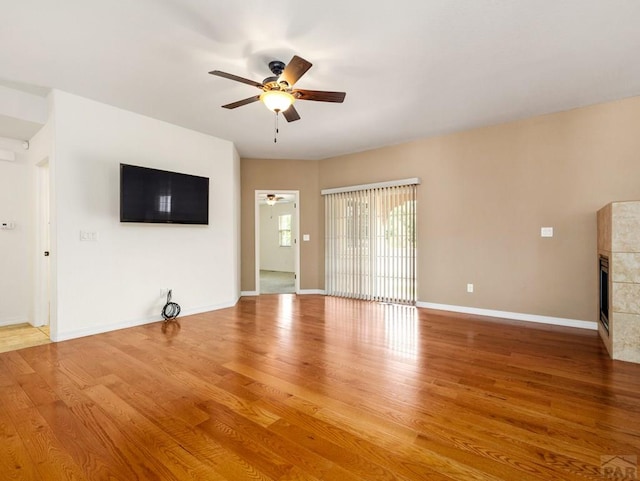5522 Ventana Ct, Pueblo, CO 81005 - unfurnished living room with ceiling fan, wood finished floors, and a fireplace