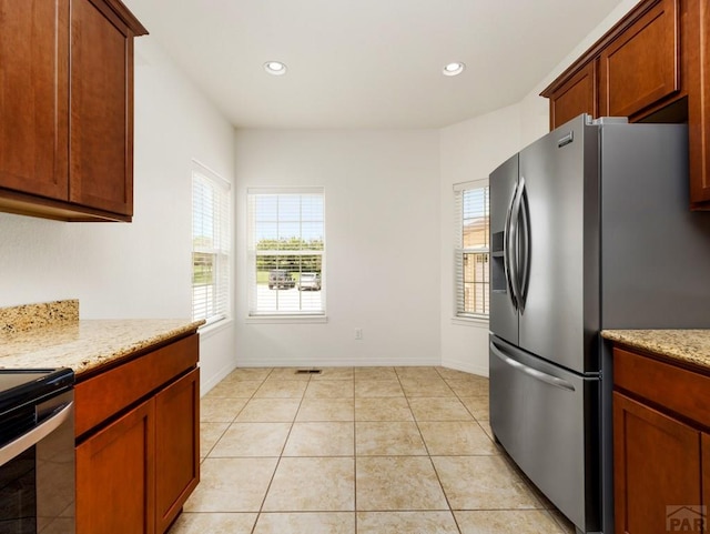 5522 Ventana Ct, Pueblo, CO 81005 - kitchen with stainless steel refrigerator with ice dispenser, plenty of natural light, electric range oven, recessed lighting, and light tile patterned floors