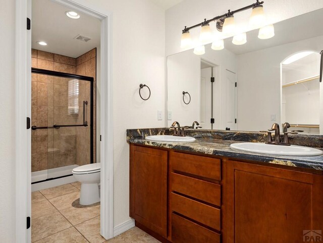5522 Ventana Ct, Pueblo, CO 81005 - full bathroom with a stall shower, double vanity, and tile patterned flooring