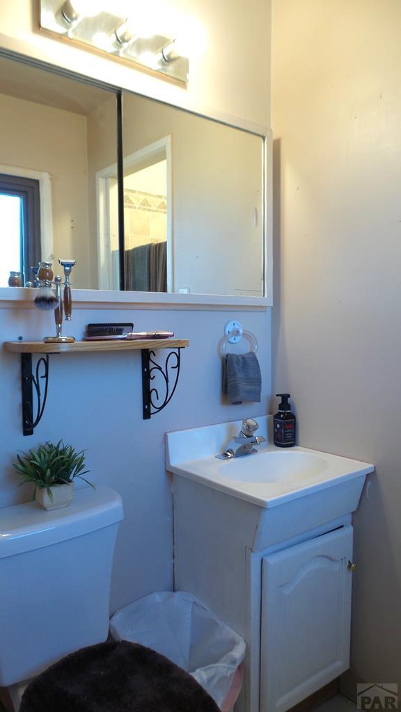 bathroom featuring toilet and vanity