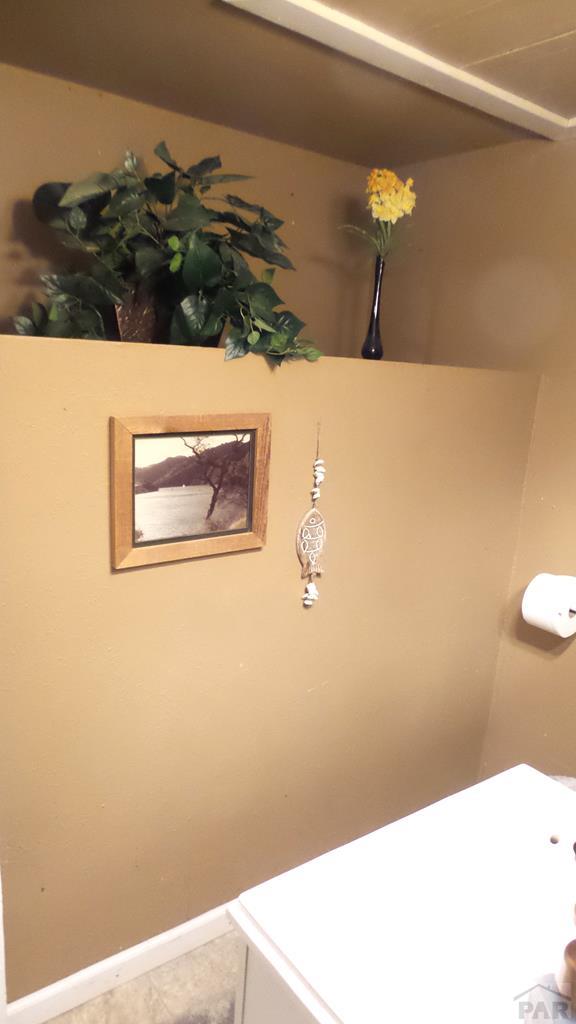 bathroom with baseboards and tile patterned floors