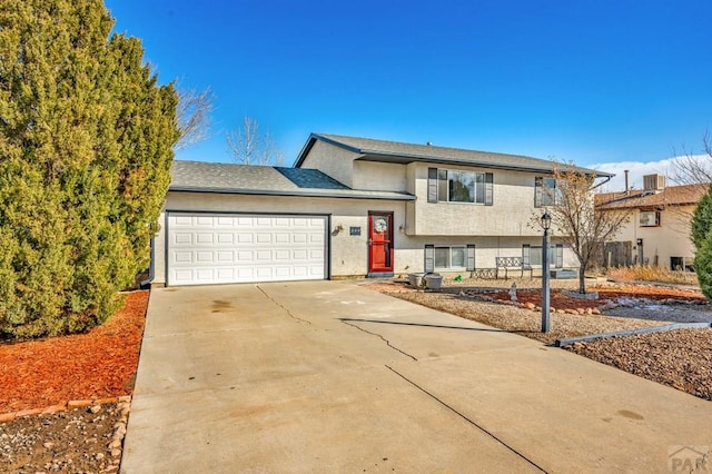 tri-level home featuring a garage and driveway