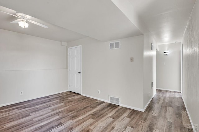 spare room featuring visible vents, light wood-style flooring, and baseboards