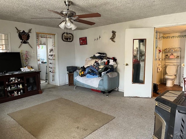 living area with washer / dryer, carpet flooring, a ceiling fan, and a textured ceiling