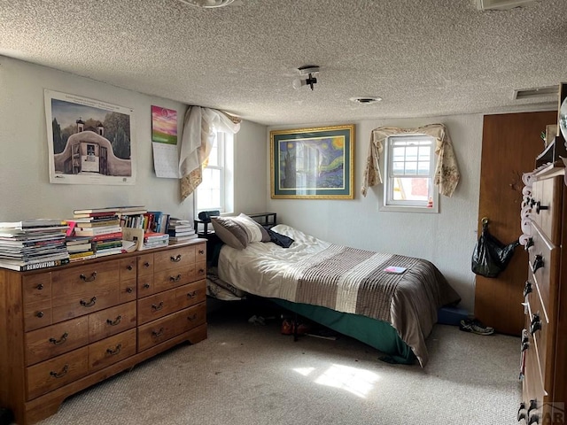carpeted bedroom featuring a textured ceiling