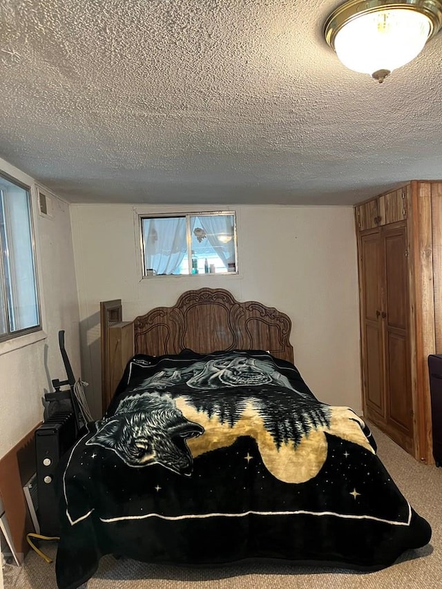 bedroom with carpet floors and a textured ceiling
