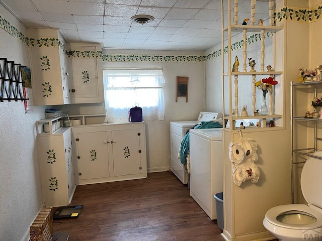 washroom featuring washer and dryer, laundry area, dark wood-style floors, and visible vents