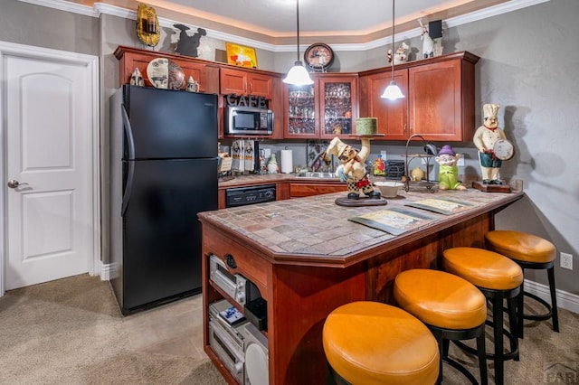 1700 Aquila Dr, Pueblo, CO 81008 - kitchen featuring black appliances, tile countertops, a peninsula, crown molding, and a kitchen breakfast bar