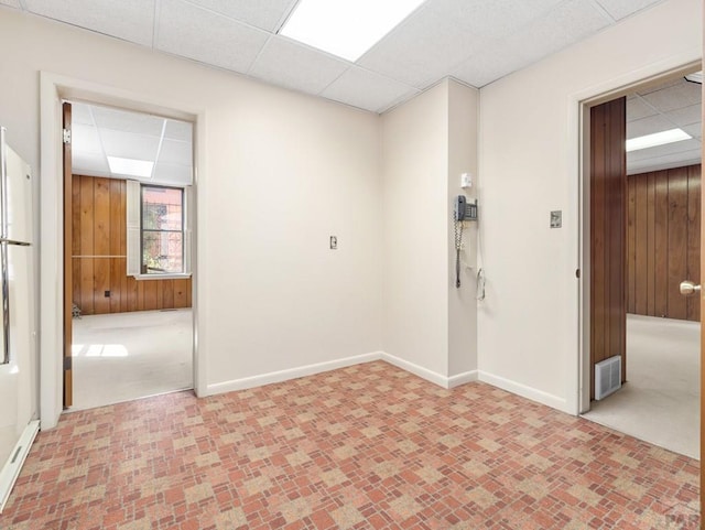 215 E Pitkin Ave, Pueblo, CO 81004 - unfurnished room with a paneled ceiling and wood walls
