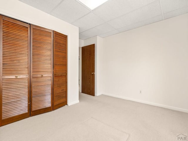 215 E Pitkin Ave, Pueblo, CO 81004 - unfurnished bedroom with light colored carpet, a closet, and a paneled ceiling
