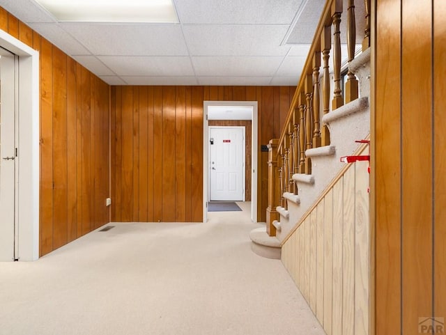 215 E Pitkin Ave, Pueblo, CO 81004 - carpeted entryway with stairs and wooden walls
