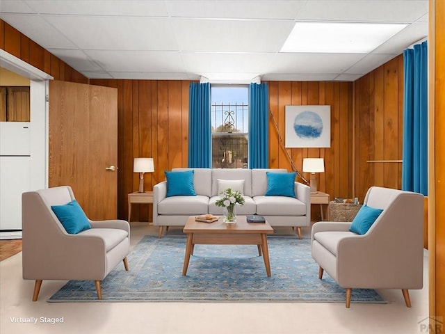215 E Pitkin Ave, Pueblo, CO 81004 - living area featuring wood walls and a drop ceiling