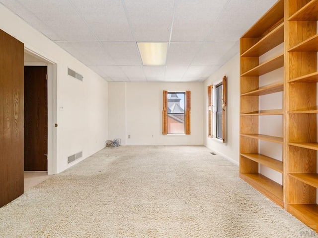 215 E Pitkin Ave, Pueblo, CO 81004 - carpeted empty room with a paneled ceiling