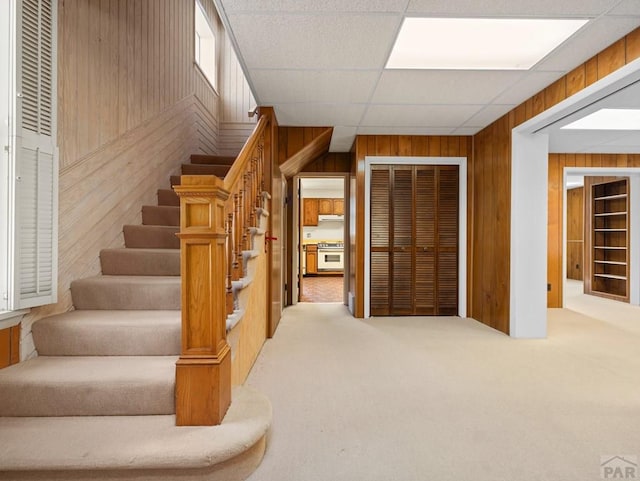 215 E Pitkin Ave, Pueblo, CO 81004 - staircase featuring wooden walls and carpet