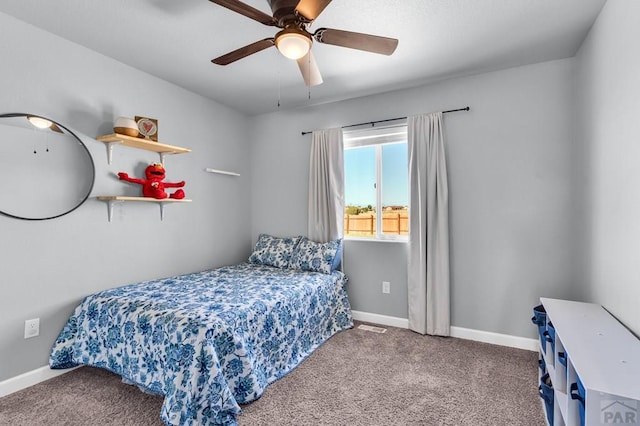 1207 N Jon Ln, Pueblo West, CO 81007 - carpeted bedroom featuring baseboards and ceiling fan