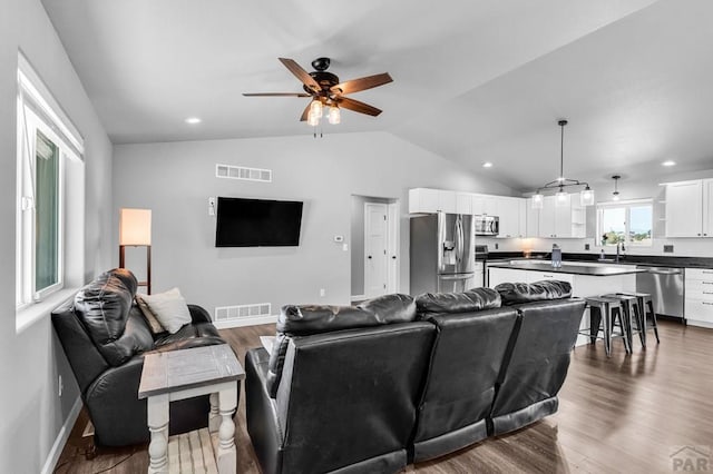 1207 N Jon Ln, Pueblo West, CO 81007 - living room with ceiling fan, lofted ceiling, dark wood-style flooring, and recessed lighting