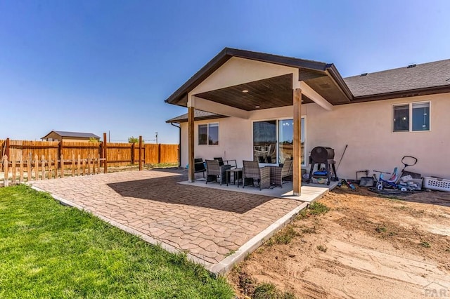 1207 N Jon Ln, Pueblo West, CO 81007 - rear view of house featuring stucco siding and a patio area